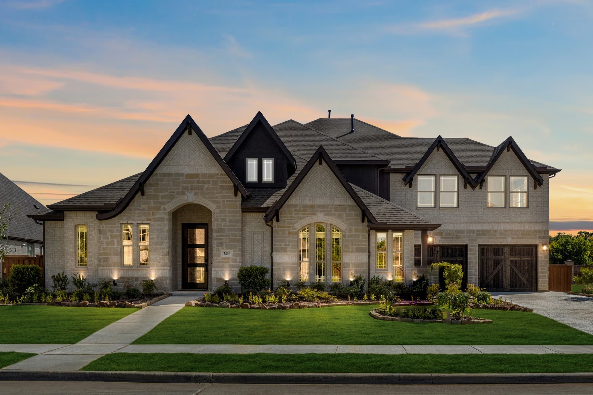 Stone-and-brick custom home at dusk